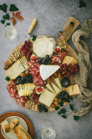 Caterer on booth Board of aged cheeses